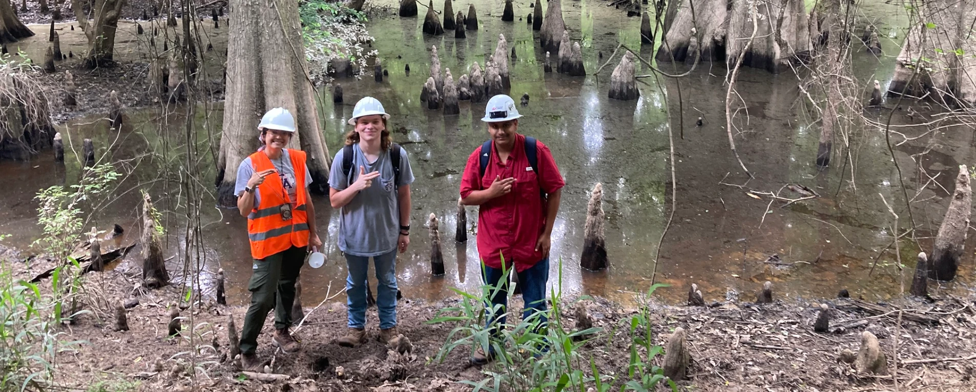 enviromental science students at a forest pond