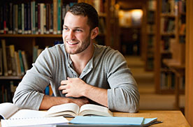 young man studying in a library