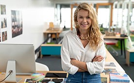 young woman standing and smiling in an office setting