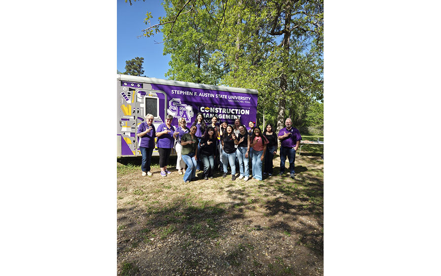 Construction Management faculty and students in front of their trailer