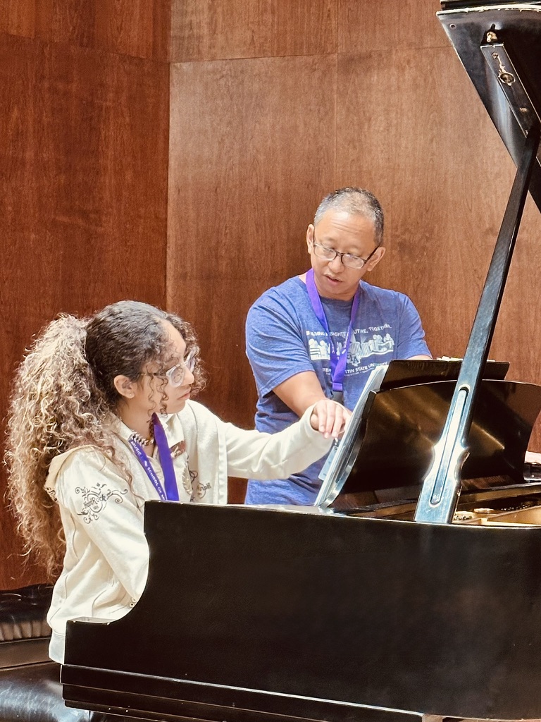 A student works with a faculty pianist