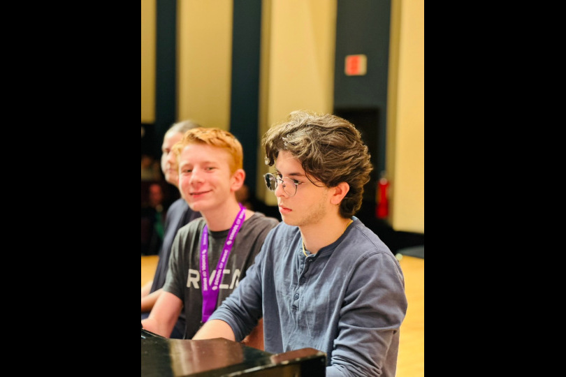Two students work together on a piano duet