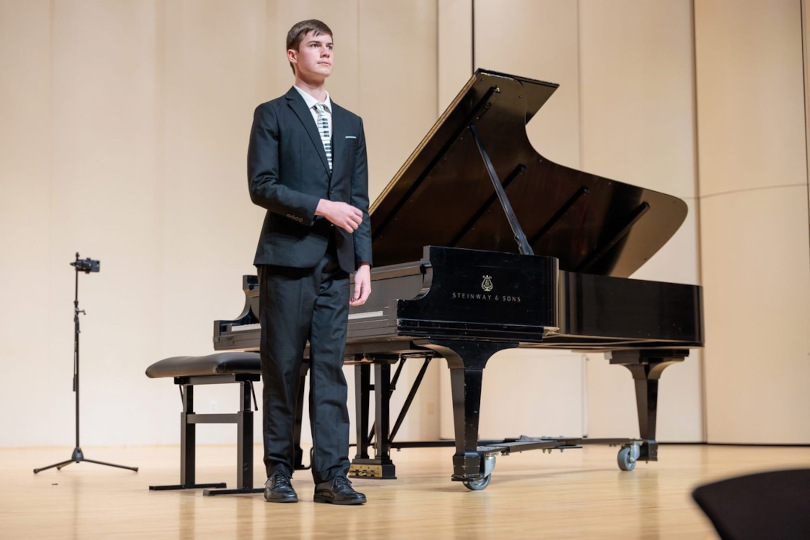 A student recognizes the crowd during a performance