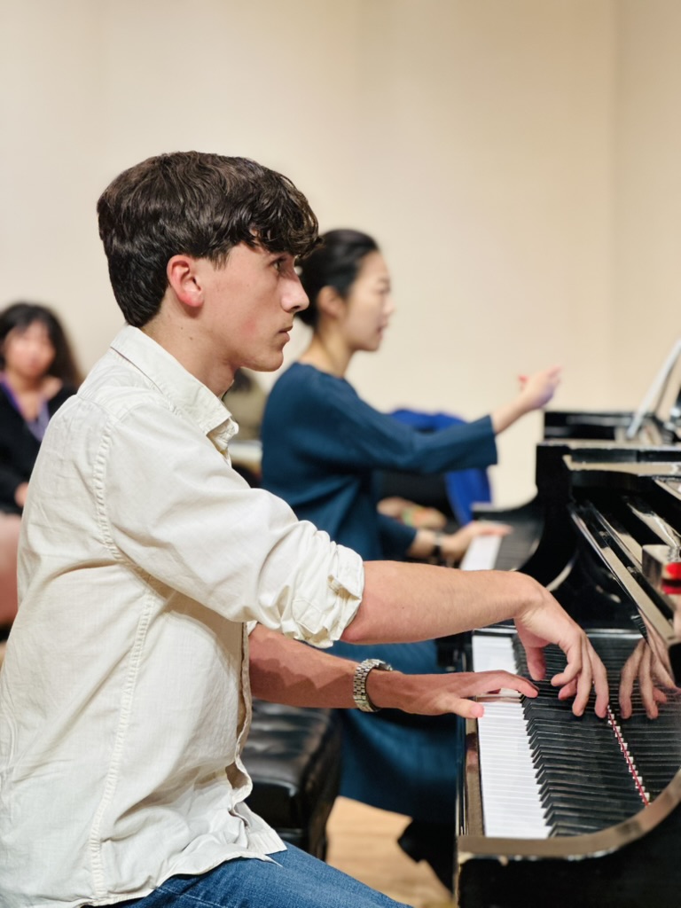 A student and faculty member perform together