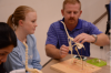 Dr. Bray showing student chicken skeleton