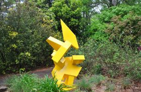 A brightly-colored yellow sculpture in the SFA Gardens