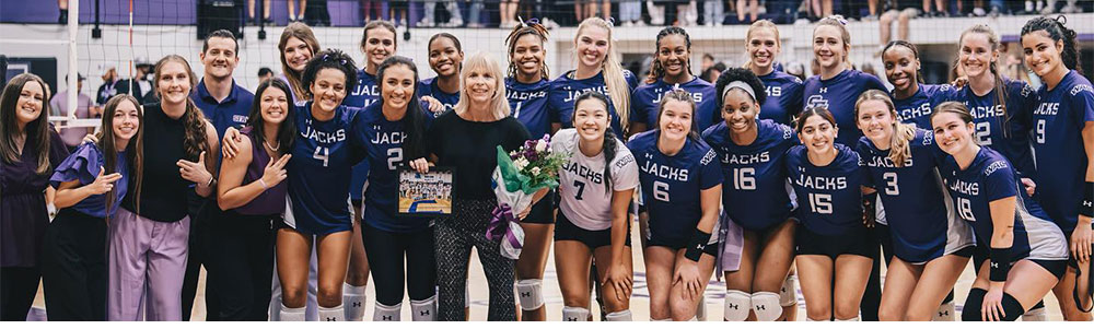 Debbie Humphreys, center, poses with members of the SFA volleyball team after Humphreys earned her 800th career victory in a reverse sweep over Boise State University Sept. 8, 2023. During her tenure, Humphreys has led her teams to 846 wins, nine NCAA Tournament appearances and 20 conference championships.