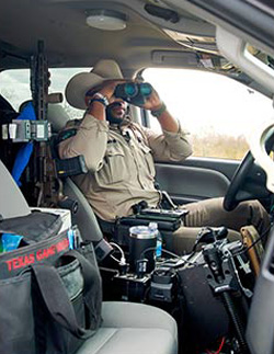 Jamal Allen keeps a lookout for hunters and anglers who may be in violation of the law. Allen, like all Texas game wardens, is a fully commissioned state peace officer, meaning he is responsible for the enforcement of all Texas criminal laws.
