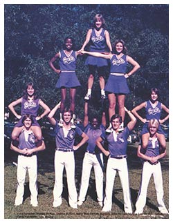 Ty Woodfolk, pictured in the middle at the base of a cheerleading pyramid, was a member of the cheer squad that created SFA's iconic "axe 'em" hand sign. Photo courtesy of the Stone Fort yearbook, 1980 