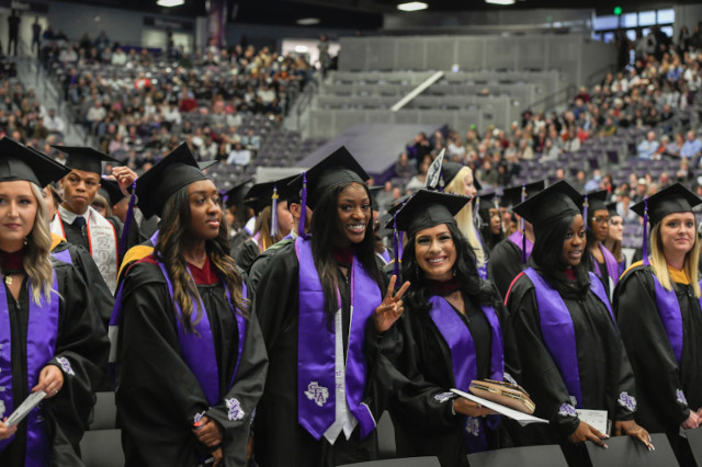 Students pose for a photo during commencement