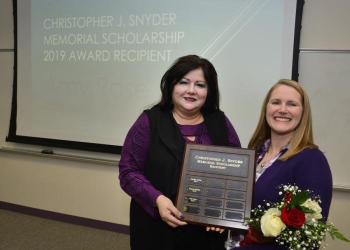 Kim Luna presents Amy Rose, a senior from Fort Worth enrolled in Stephen F. Austin State University’s orientation and mobility program, with the Christopher J. Snyder Memorial Scholarship.