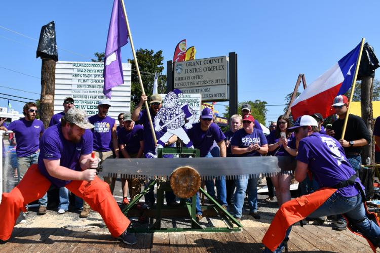 SFA Sylvans team members Ian Erickson and John Mike Arnett participate in the crosscut saw competition.