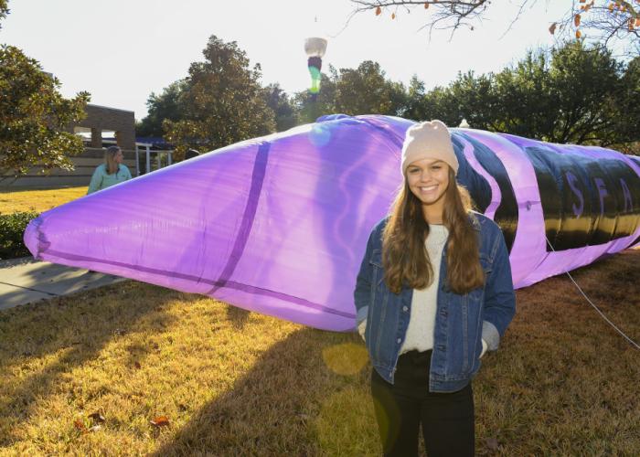 SFA junior Jenna Lowry pictured with the purple crayon inflatable sculpture