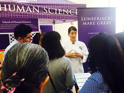 Dr. Donna Fickes, clinical instructor in hospitality administration, addresses a group of students.