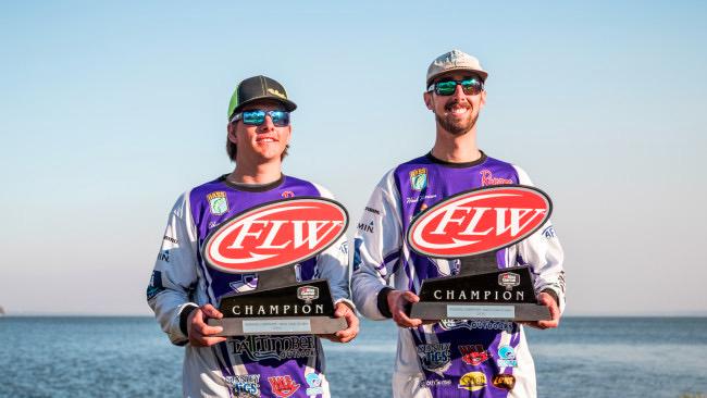 Ethan LeGare and Hank Harrison holding trophies