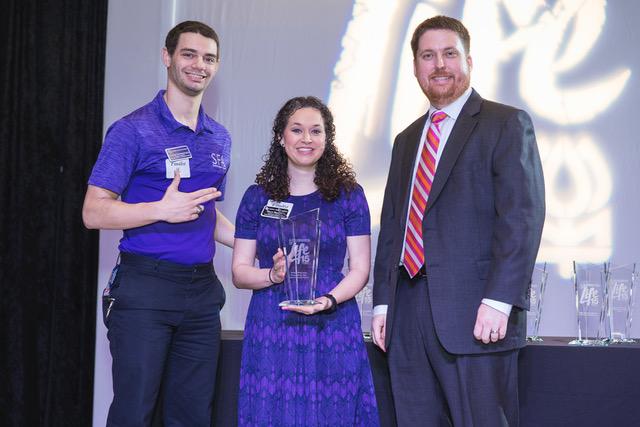 Collin Rutherford and Molly Moody accept the Gulf Coast Regional Blood Center award for “College of the Year” from Kevin Shipley.