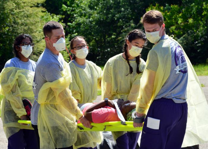 Senior students enrolled in Stephen F. Austin State University’s DeWitt School of Nursing carry a patient to a treatment station during a disaster drill.