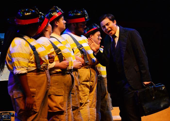 A chorus of firefighters confront Cumming, Georgia junior Shane Reynolds as Gottlieb Biedermann in the SFA School of Theatre’s presentation of Max Frisch’s “(Biedermann and) The Firebugs.”
