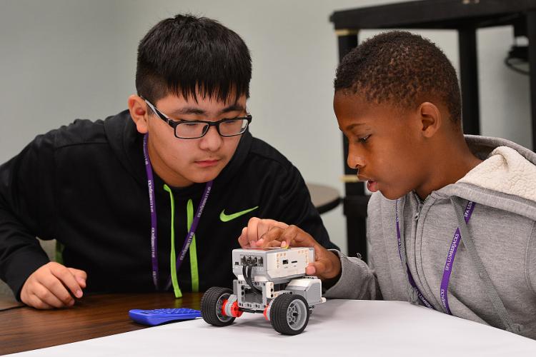 two middle school students with their robot