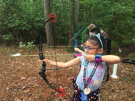 A student tries out archery at last year's Archery and Survival Supermarket Family Day.