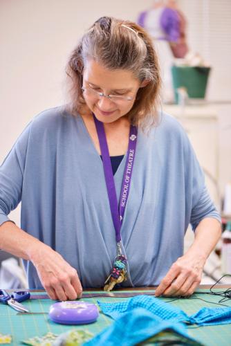 Barbara Blackwell works on assembling protective gear for Memorial Hospital medical workers.