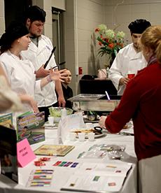 Hospitality administration student Samantha Dibilio explains her group’s dishes to “Book Bites” attendees.
