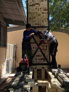 Students at La Universidad Autonoma de Chihuahua in Mexico work to construct the first wood fire kiln in Northern Mexico.