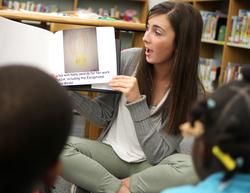 SFA senior elementary education major Morgan Dison reads the book she and her classmates created about Ellen Ochoa, the first Hispanic female astronaut.