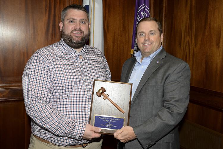 Dr. Jeremy Stovall receiving a plaque recognizing his dedication to excellence as Faculty Senate chair by SFA President Dr. Scott Gordon