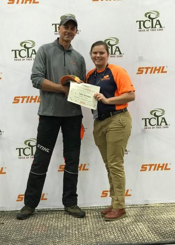 Lana Welford accepting a certificate from Mark Chisolm