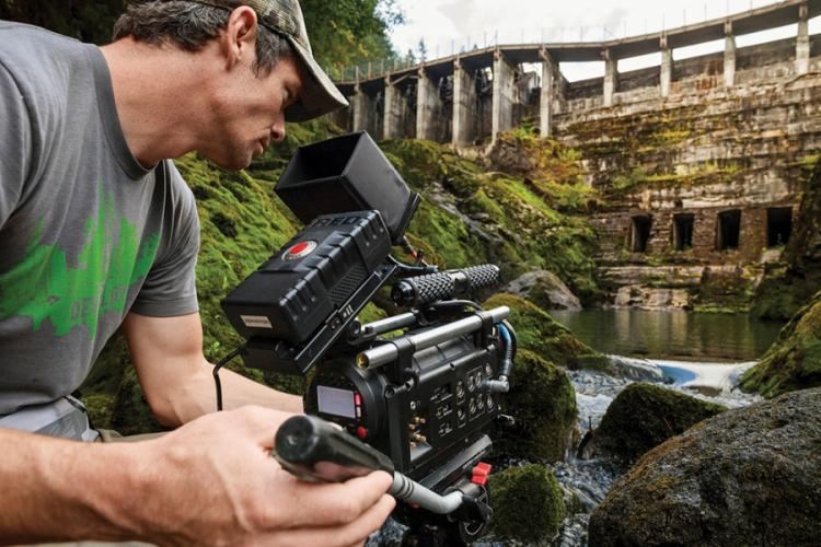 Ben Knight films the former Elwha Dam before its removal from the Elwha River in Washington in a scene from “DamNation.”