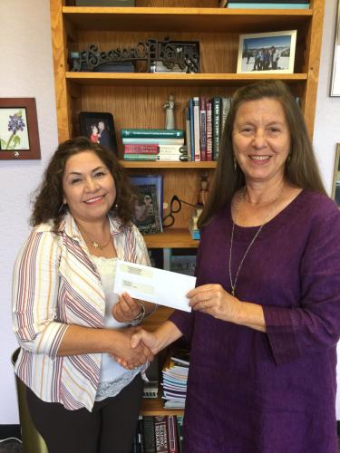  Dr. Judy Abbott presents Maria Landeros, a senior studying early childhood through sixth grade education, the 2017-18 McCathey Dressman Education Foundation Scholarship.