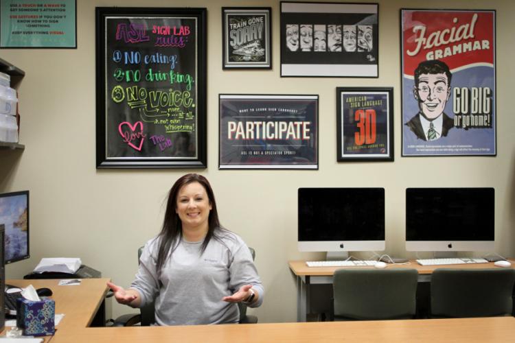 Maggie Patterson, American Sign Language instructor and ASL Lab coordinator at Stephen F. Austin State University, welcomes people to the ASL Lab by signing.