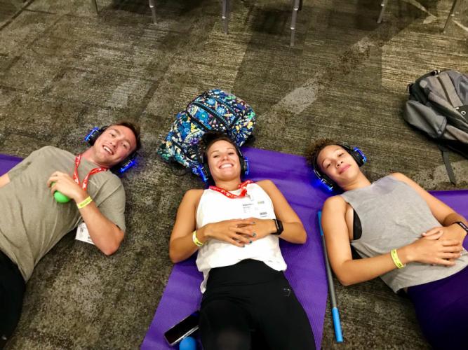SFA juniors Garrett Plumlee of Longview, Valentina Stinchfield of Tyler and Breanna Lemons of Hawkins practice meditation at a fitness conference before the COVID-19 pandemic.