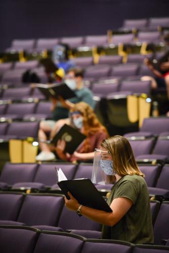 photo of SFA voice students rehearsing with face masks and shields