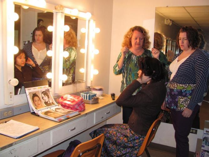 Angela Bacarisse helps student performers design hair and makeup for the School of Theatre's production of "Stage Door" in this 2013 file photo.
