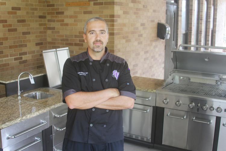 Chef Todd Barrios standing in the new outdoor kitchen