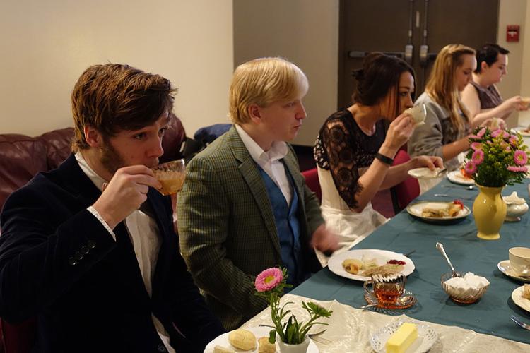 "The Importance of Being Earnest" cast members participate in a formal tea to prepare for their roles.