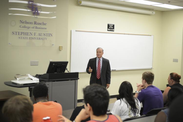 Carlos Cascos, Texas secretary of state, speaking to a class of economics students.