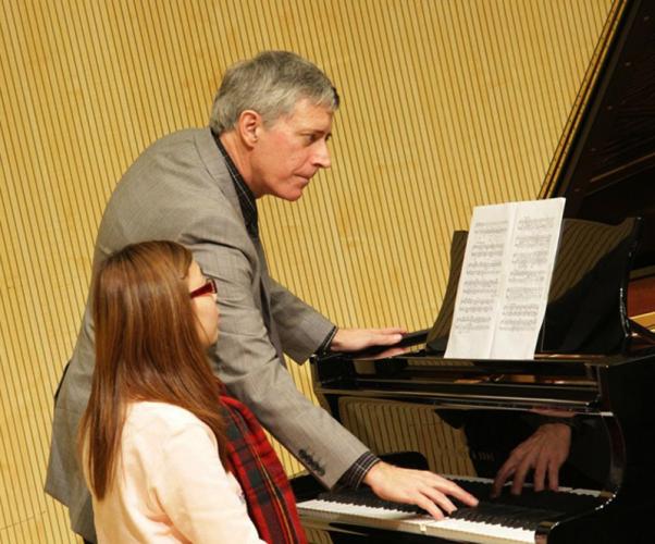 Dr. Andrew Parr, professor of piano in the Stephen F. Austin State University School of Music, instructs a student while conducting a master class in piano at Hong Kong Baptist University.