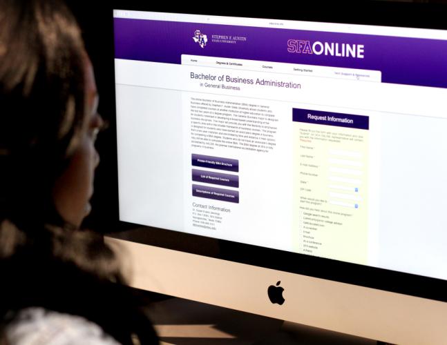photo of student in front of a computer screen