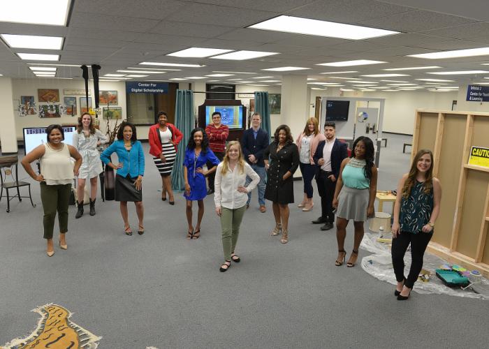 a photo of senior interior design students and their exhibits in the Steen Library