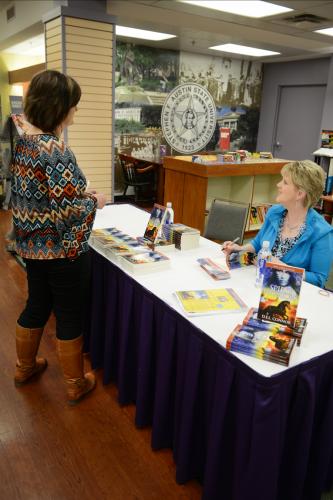 Dr. Della Connor visits with a fan of her new book "Spirit Warriors: The Concealing" during a recent book signing at the Barnes & Noble bookstore on campus.