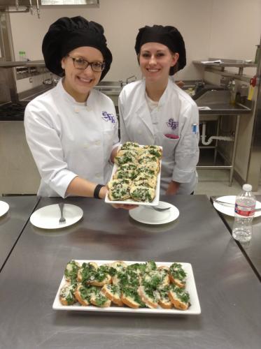 SFA students Mallory Jurena and Hollin Jordan prepared a mozzarella pesto bruschetta with ingredients from Appleby Community Farm in Nacogdoches.