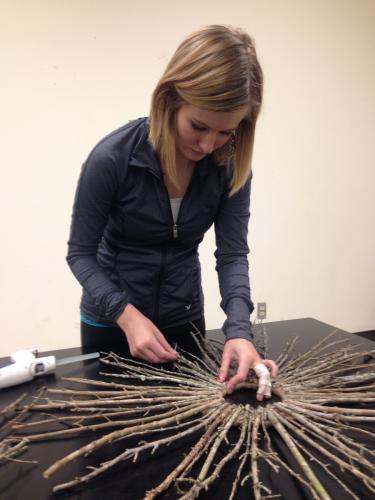SFA sophomore Sarah Weatherford assembles a wreath made from materials gathered from nature