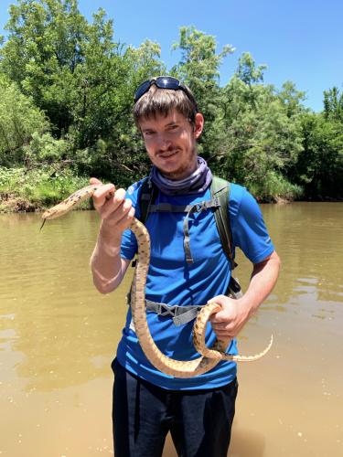 SFA biology student Kasey Jobe holding a snake