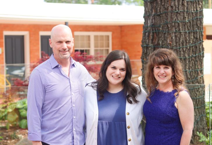 Rachel Rucker, center, celebrates with her parents, Randy and Linda