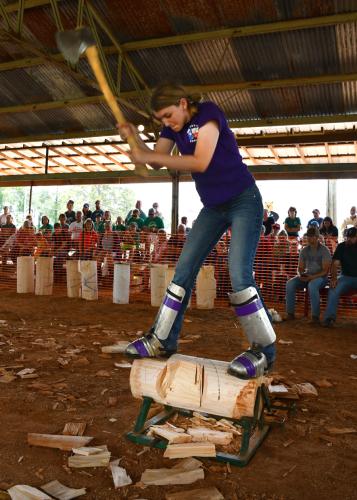 SFA’s Paige Sumner competes in the women’s log chopping competition