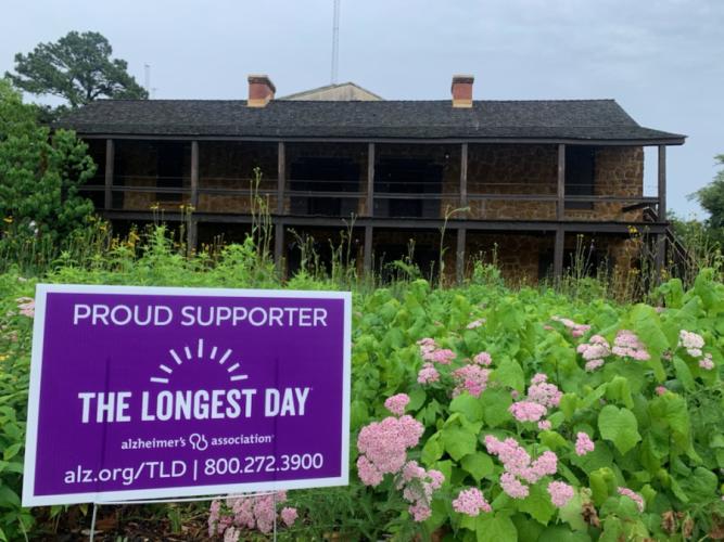 SFA's Stone Fort Museum with a sign showing it is a proud supporter of The Longest Day