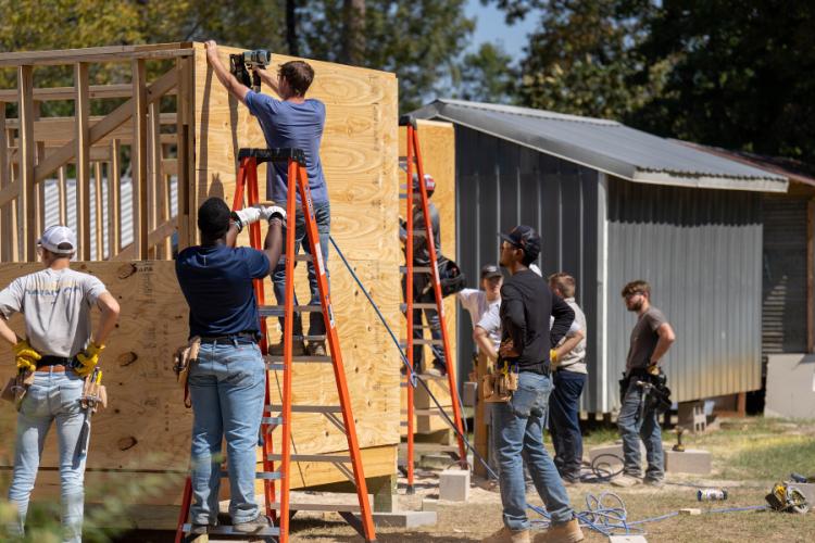 students from SFA's School of Human Sciences building a tiny home
